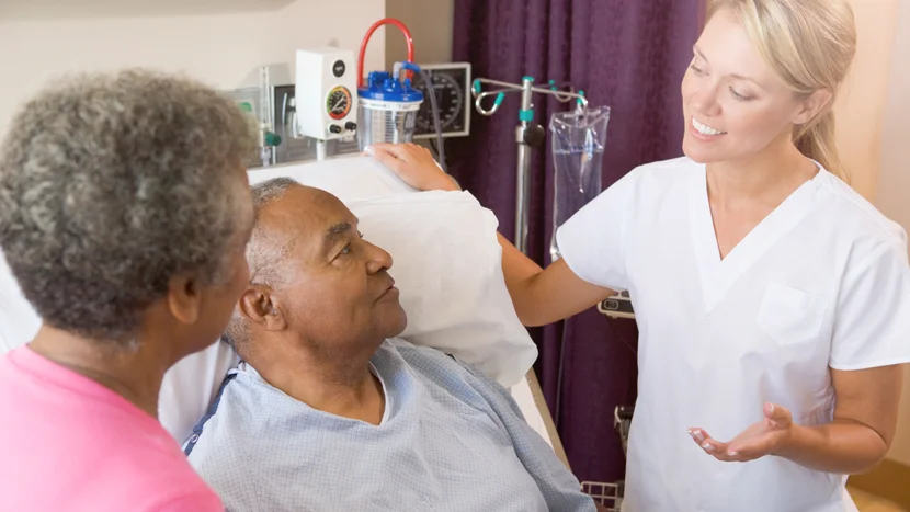 a doctor speaking to a patient and his wife